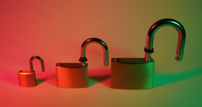 two green padlock on pink surface